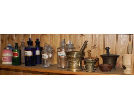 Collection of ceramic and glass chemists jars and bottles together with eight mortars and pestles