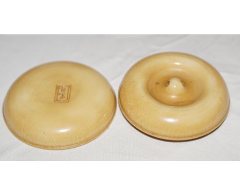 Late 19th early 20th century Japanese ivory netsuke in the form of a circular disc which unscrew to reveal two intricately ca
