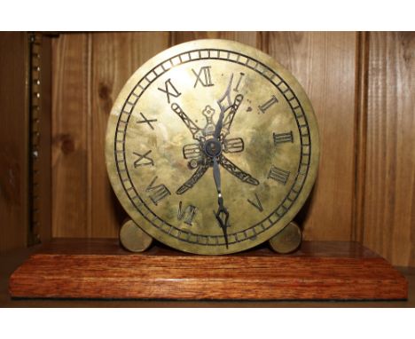 Brass cylinder double-sided mantle clock made from brass shell cases with centre crossed swords motif