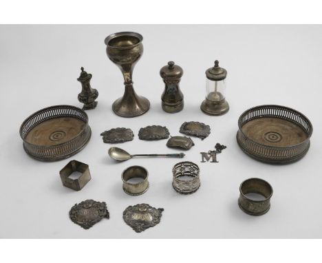 A MIXED LOT:- A pair of pierced wine coasters with turned wooden bases, London 1976, a mounted pepper mill, an Edwardian moun