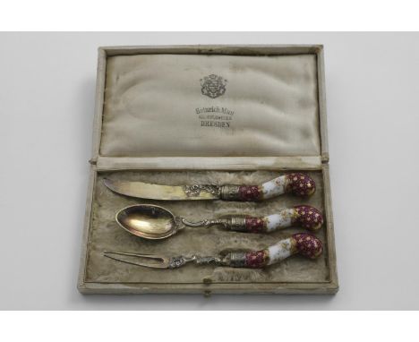 A LATE 19TH CENTURY GERMAN SILVERGILT-MOUNTED PORCELAIN CHRISTENING KNIFE, FORK &amp; SPOON in a lined and fitted case with t