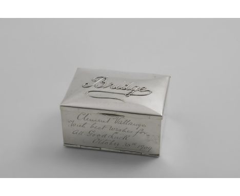 AN EDWARDIAN RECTANGULAR PLAYING CARDS BOX with the relief word "Bridge" on the cover and a fall front with a small inscripti