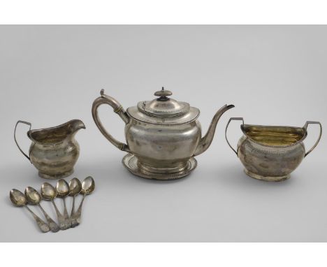 A GEORGE III TEA SET with oval bodies, gadrooned borders and an engraved frieze of repeating Greek-key motifs, to include tea