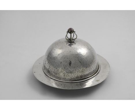 AN ART &amp; CRAFTS ELECTROPLATED MUFFIN DISH &amp; COVER with a hammered finish, the wirework finial set with an amethyst qu