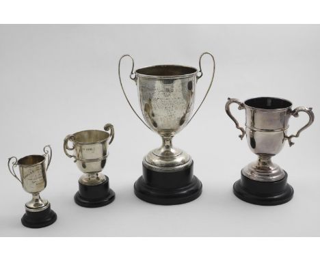 AN EDWARDIAN TWO-HANDLED TROPHY CUP "Taunton Bicycle Club...1910", &amp; three other smaller trophy cups (one inscribed), all