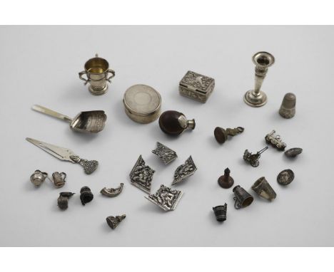 MISCELLANEOUS SMALL ITEMS:- Two small boxes, a miniature candlestick, a miniature three-handled cup, a bookmark, a caddy spoo