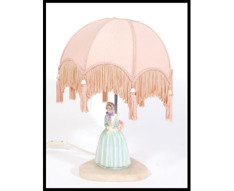 A Royal Doulton ceramic figurine lamp of a lady in crinoline dress holding a bunch of flowers, raised on plinth base with sha