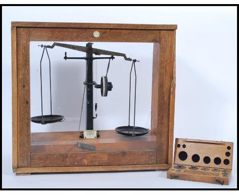 A vintage retro 20th century oak cased set of scientific apothecary weighing balance scales with ivorine makers plaque for Ph