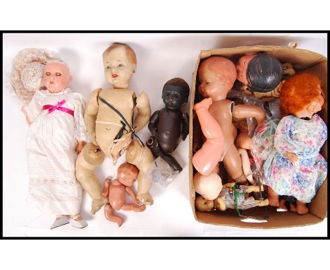 A good large collection of assorted vintage dolls, doll parts, clothing and related items. To include; an antique German Hand