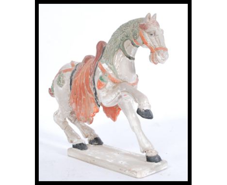 A Chinese Tang dynasty style ceramic figurine of a horse raised on a plinth base with painted details.&nbsp;measures: 28cm hi