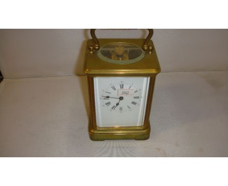 Early 20th century striking carriage clock in brass and bevelled glass case, with Arabic numbered outer chapter ring and Roma