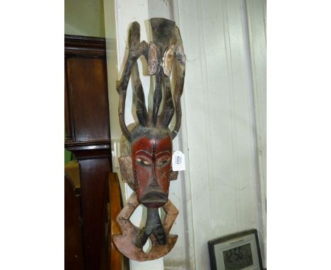 An African Baule portrait mask from Ivory Coast having beard and scarification and an ornately carved bird crest, 24" long.