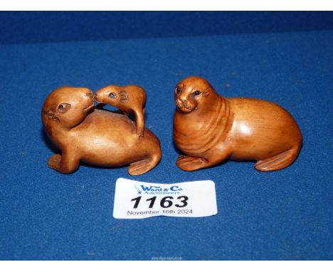 Two contemporary netsuke Seals with black bead eyes.