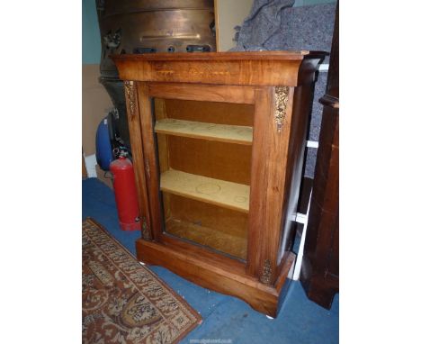 A Walnut 19th century Pier Cabinet having boxwood inlay to the frieze and boxwood stringing, the glazed door revealing a brow
