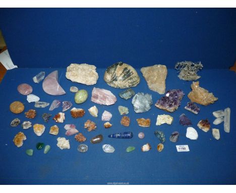 A quantity of rough and polished semi-precious stones and a Mother of pearl shell.