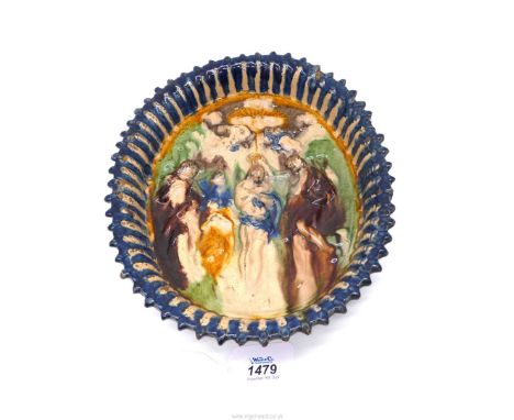 In the manner of Bernard Palissy early 17th century, a French oval Dish moulded and painted in polychrome with the baptism of