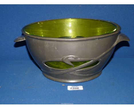 Archibald Knox for Liberty; a Tudric Pewter fruit Bowl, (pattern 0318), exceptionally with its original green glass liner, fu