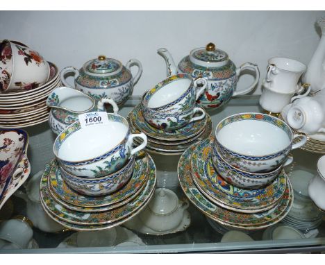 A Chinese teaset decorated with cockerels and foliage in bright colours and gilt detail including six cups and saucers and te