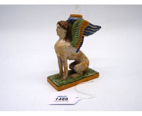 A 19th century Majolica Candlestick in the form of a sphinx decorated in polychrome, probably South Italian, second half of t