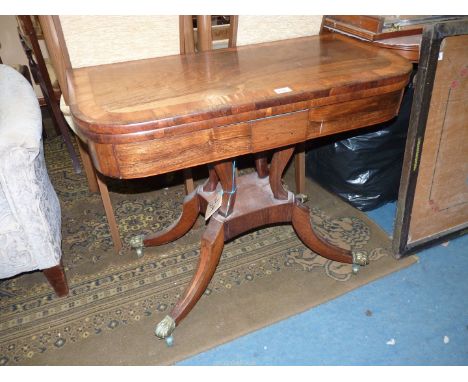 A stylish and desirable 19th c. cabinet maker flapover Card Table having a broad cross-banding to the Rosewood top and standi