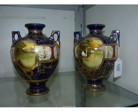 A pair of Noritake vases having blue ground with panels depicting swans on a lake, 8" tall.