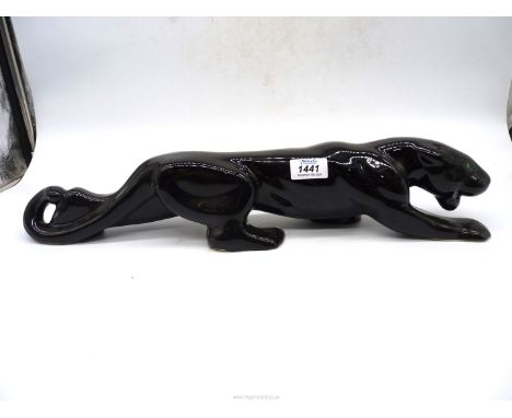 A large ceramic figure of a black puma.