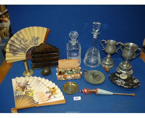 A quantity of miscellaneous to include: an orthoceras ammonite fossil, papier mache letter rack, two glass decanters, marbles