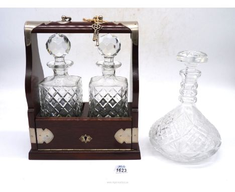 A double Tantalus with keys and a cut glass ship's Decanter.