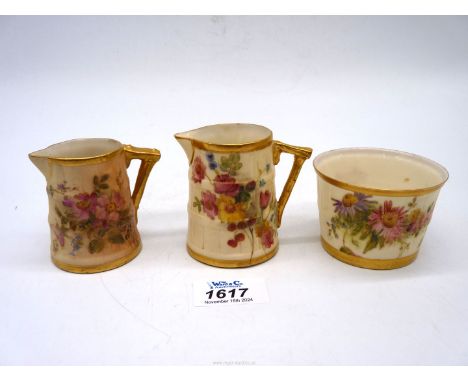 Three small pieces of Royal Worcester, two cream jugs with barrel effect finish and a similar bowl with floral decoration and