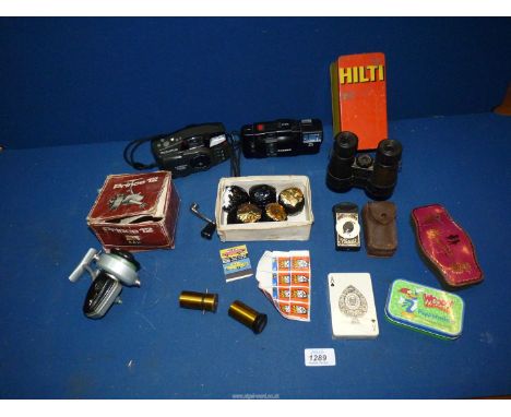 A Busch Rathenow Galinett 3.5 x 38 Binoculars, mixed tins, early Ben Sawyer golf balls together with two Olympus cameras one 