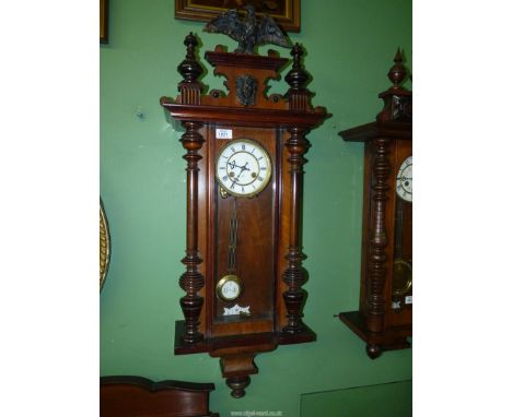 A German walnut Wall Clock by Junghans, striking the hours and half hours, with original pendulum and key, having detachable 