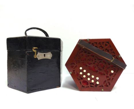 A CONCERTINA  the hexagonal fret-cut mahogany ends with twenty-one buttons, the five-fold dark green leather bellows with dec