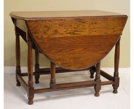 Oak two flap oval gate leg dining table on turned supports   Condition: 