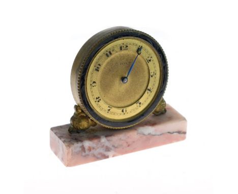 Small early 20th Century brass and enamel cased timepiece, the dial with Arabic numerals, pink marble base   Condition: 