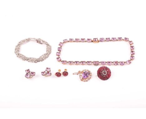 A 9ct yellow gold, amethyst, and seed pearl brooch, of oval design, approximately 2.4 cm wide, with attached safety chain, to