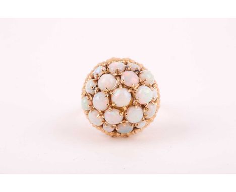 A mid to late 20th century yellow gold and opal bombe ring, the domed mount set with round cabochon opals, the shank marked 5