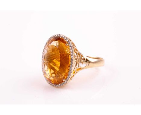 A 14ct yellow gold, diamond, and citrine cocktail ring, set with a large mixed oval-cut citrine measuring approximately 21 x 