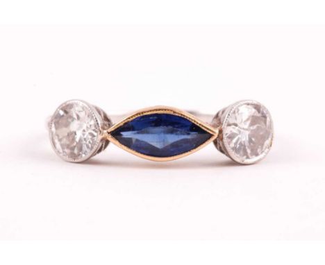 A diamond and blue stone ring, collet-set east to west with a marquise-shaped blue stone, flanked with two old-cut diamonds o