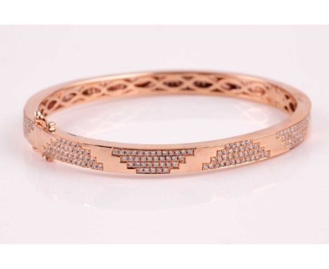 An 18ct rose gold and diamond bracelet; the polished bangle with pave set round brilliant cut diamond panels; concealed clasp