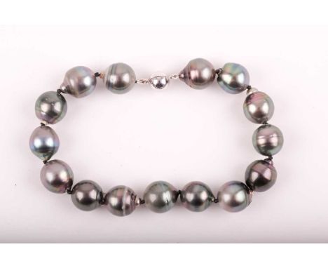 A South Sea black pearl bracelet, the rounded pearls approximately 12mm diameter, fastened with an 18ct white gold magnetic b