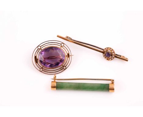 A single stone amethyst brooch; the circular cut amethyst in collet mount within a three band openwork frame; together with a