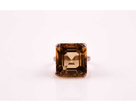 A single stone citrine ring, the square step-cut citrine, in four claw mount, foliate setting and unmarked rose coloured yell