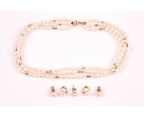 A 9ct yellow gold and pearl necklace, comprised of three strands of white cultured pearls, with yellow metal spacer beads, th