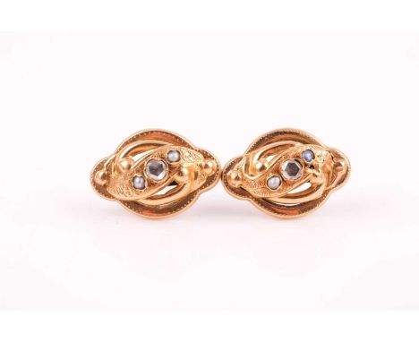 A pair of late 19th / early 20th century yellow metal, diamond, and pearl earrings, each swirled mount set with a rose-cut di