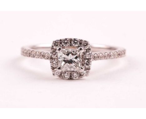 An 18ct white gold and diamond cluster ring, set with a princess-cut diamond of approximately 0.47 carats, approximate colour