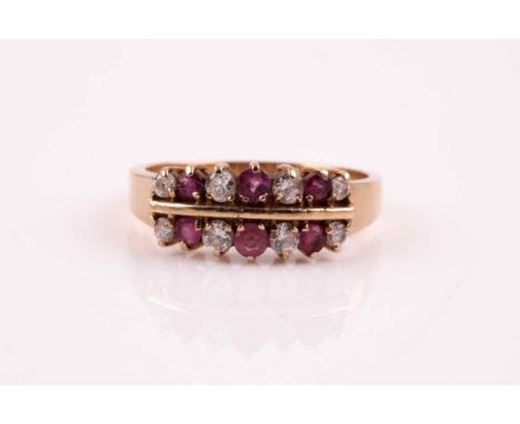 A ruby and diamond two row, half hoop ring, the round brilliant cut diamonds and circular cut rubies, in claw mounts to sligh