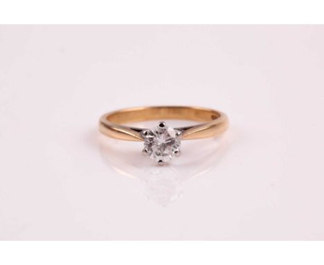 A single stone diamond ring, the round brilliant cut diamond in raised six claw bi-coloured 18 ct gold mount; diamond estimat