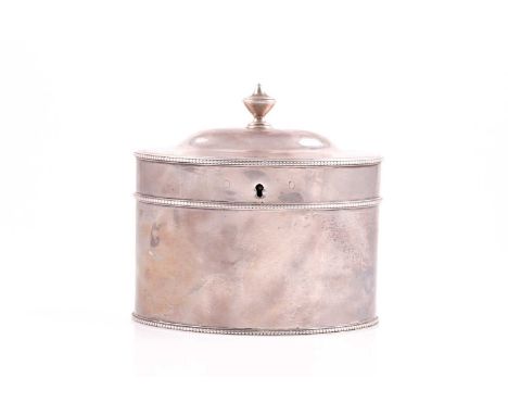 A George III tea caddy, London 1784 by William Sumner; oval with beaded borders, flat hinged cover and urn finial, 13.5 x 11.