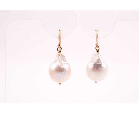 A pair of yellow metal and baroque pearl drop earrings, each set with a naturalistic pearl, 3 cm long.Condition report: Hooks