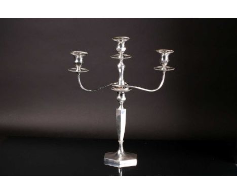 An early 20th century three branch candleabrum, the silver plated top section with three beaded detachable scones and beaded 